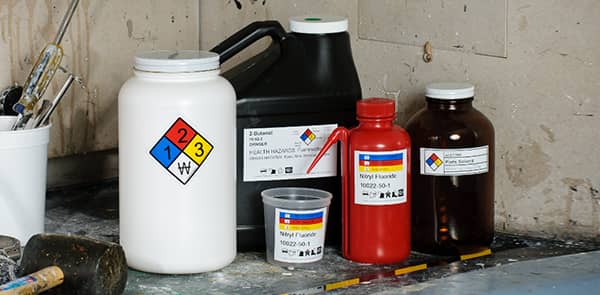Chemical product bottles with hazard warning labels